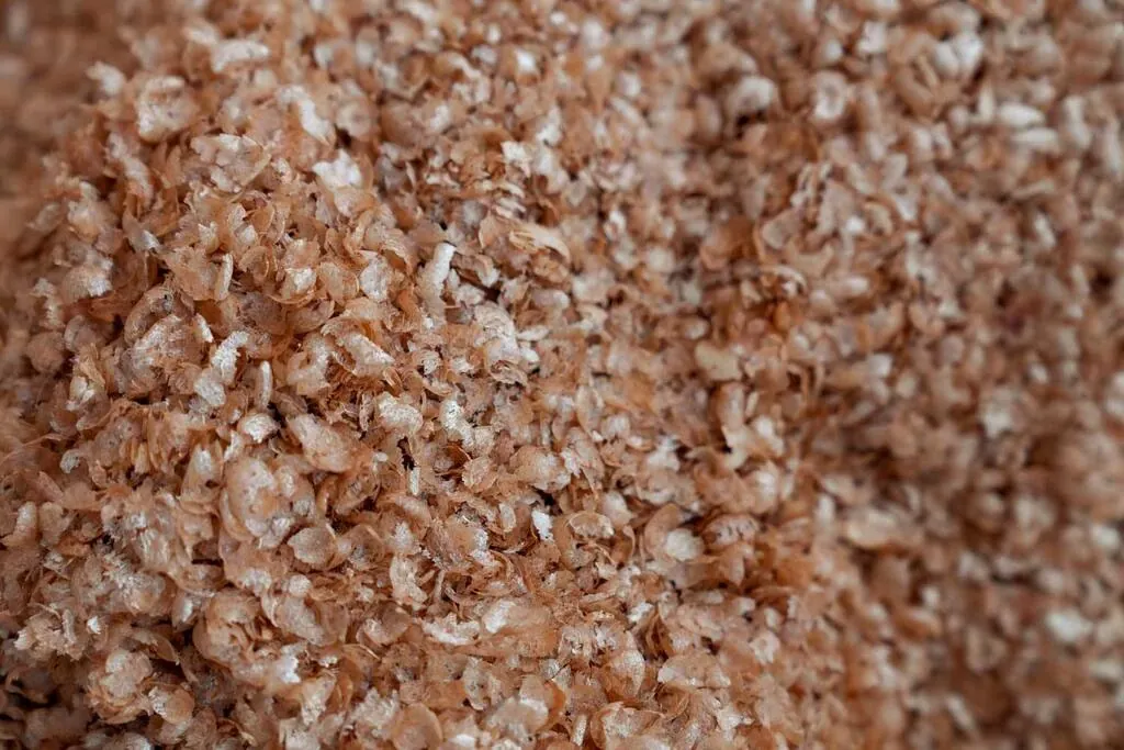 Close-up of coffee silverskin, the thin flakes released from beans during roasting